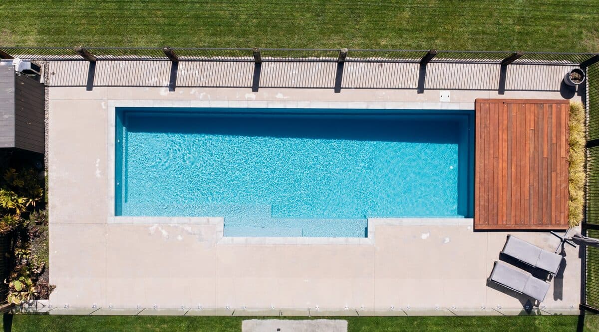 Aerial view of a long Kiwi Estate 12 pool with a timber deck at one end