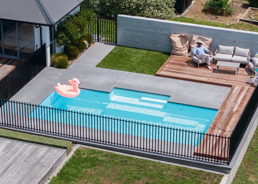 Aerial view of a Kiwi Estate 8 pool with a raised timber deck and lawn