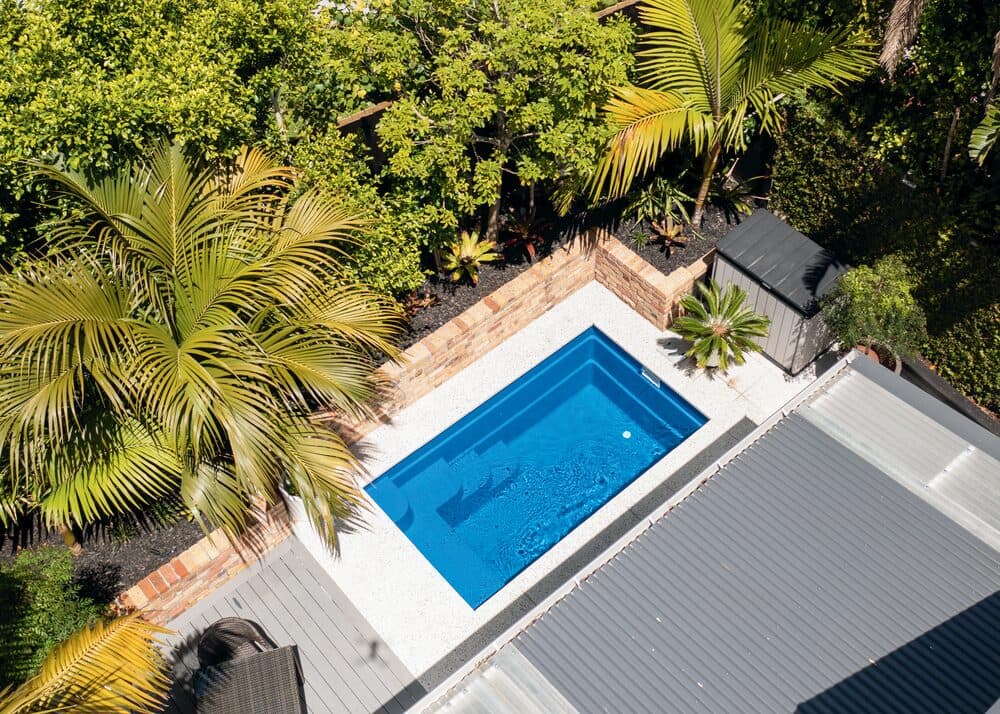 Aerial view of a Kiwi Urban 4 plunge pool among palms