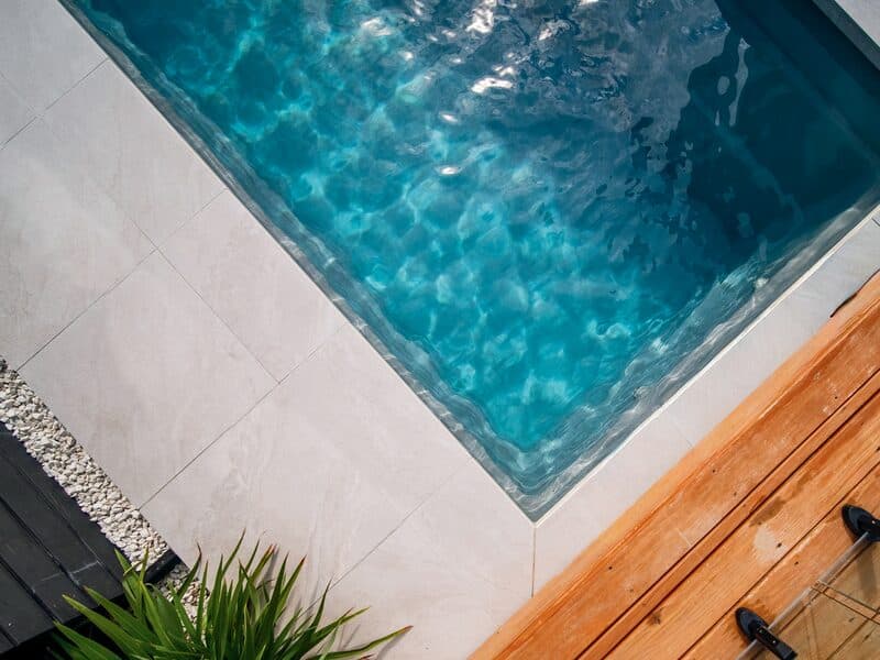 Close aerial view of the water and coping of a Kiwi Urban 5 pool