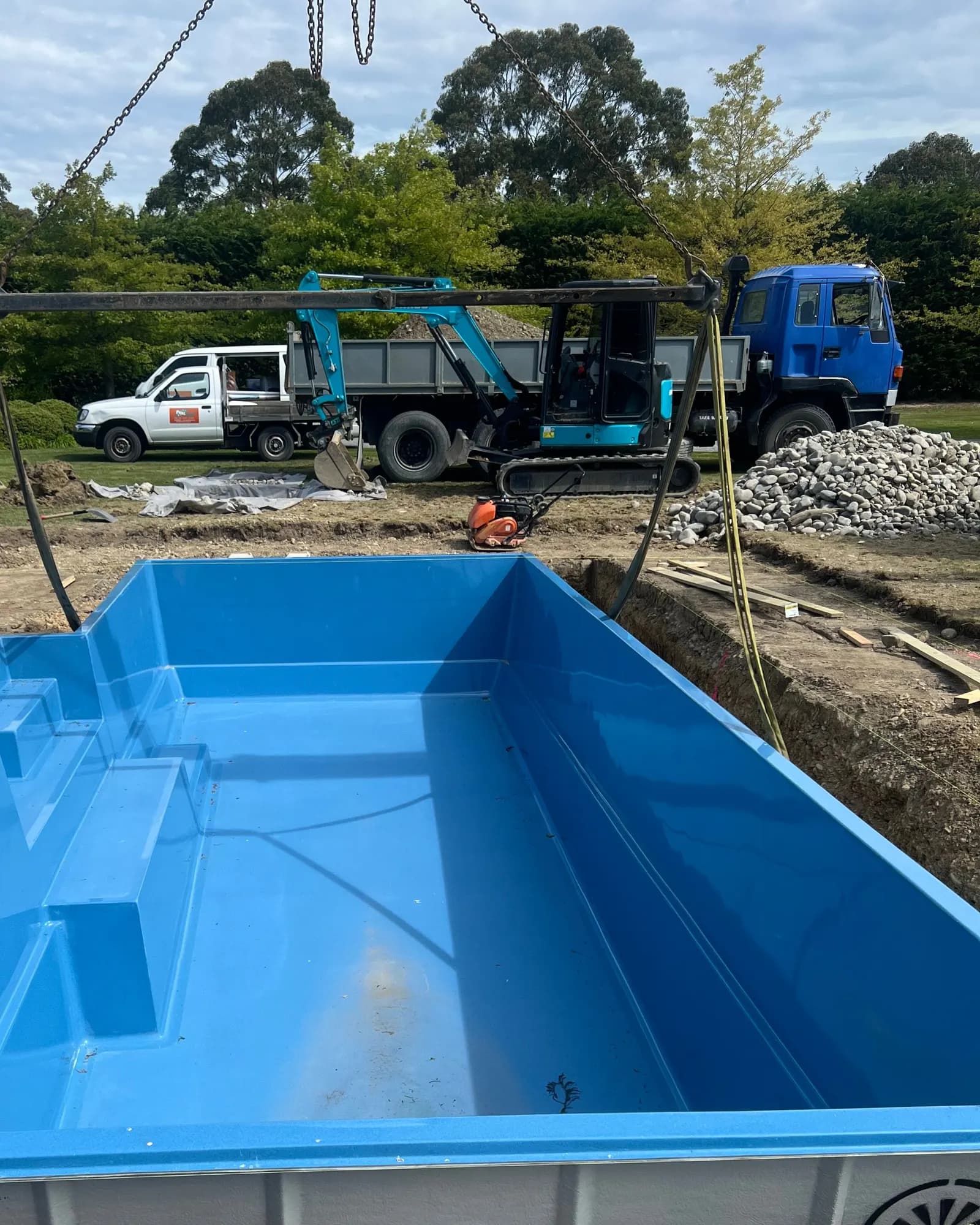 The shell settles into its excavation, its moulded entry steps and bench in the near corner